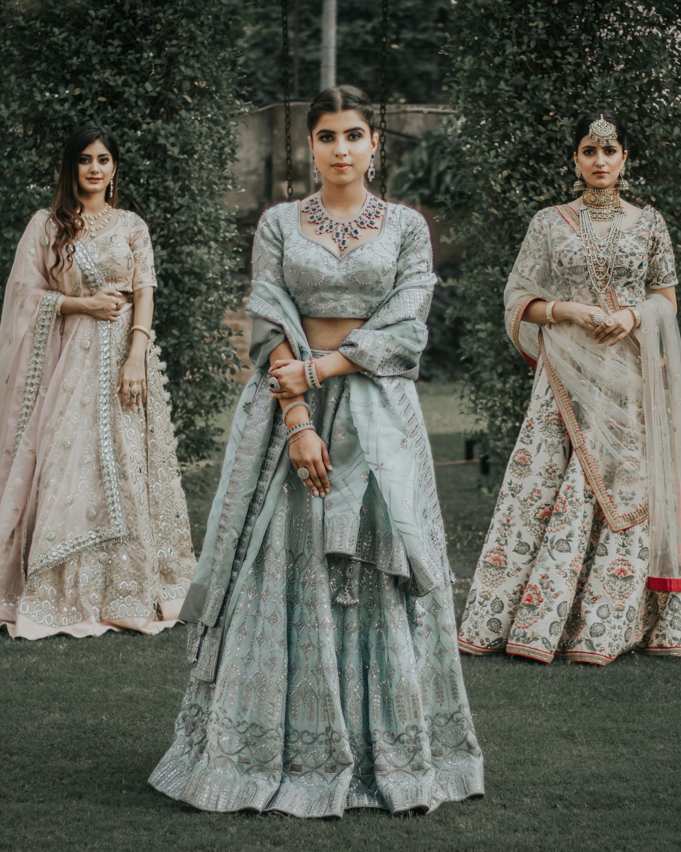 Three women wearing pieces from the Rooh collection, photographed on the steps of a heritage building