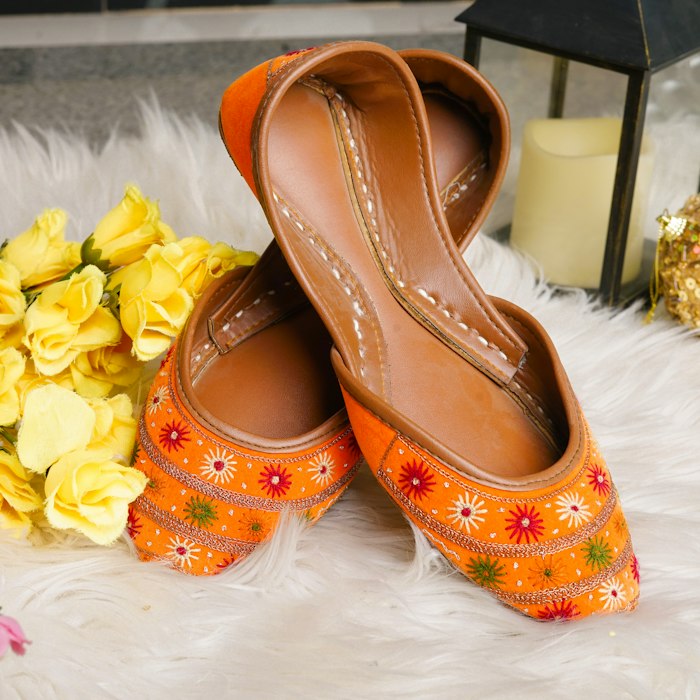 Hand-embroidered juttis styled on ivory linen